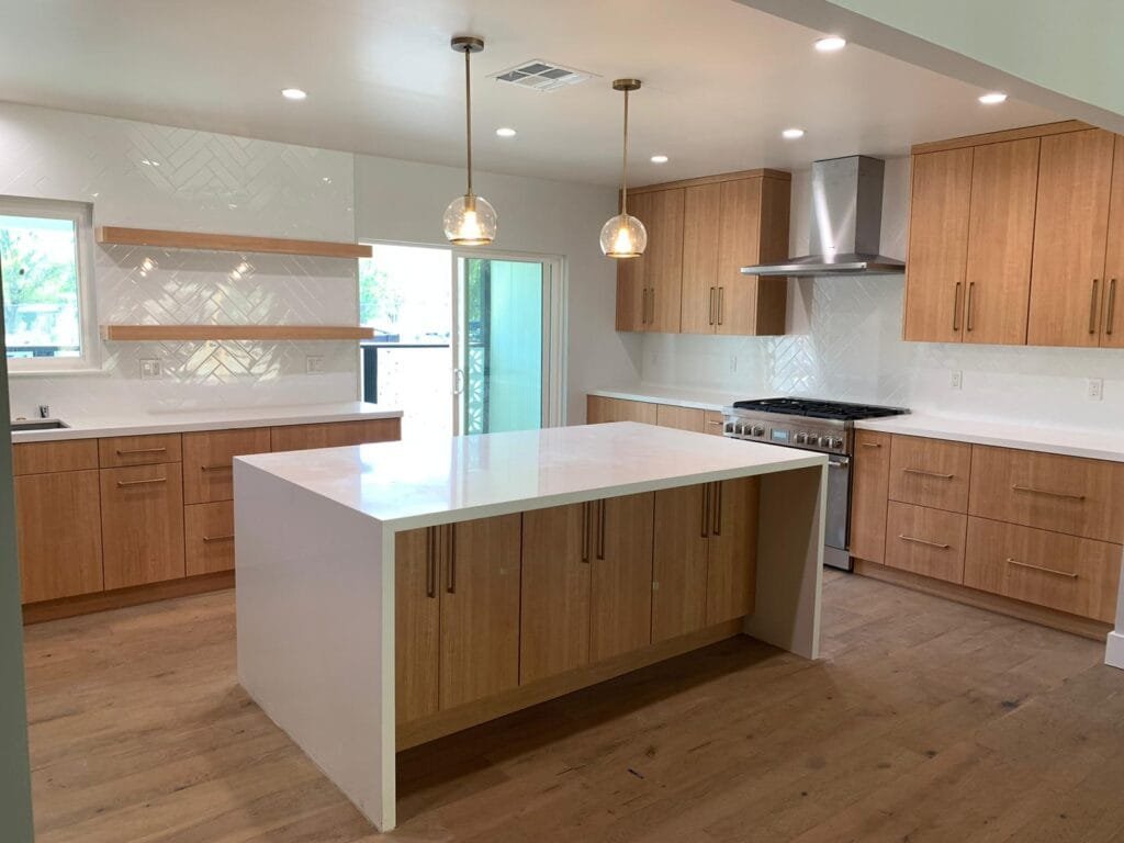 Modern Los Angeles kitchen remodel featuring natural wood cabinetry, white quartz island, open shelving, and recessed lighting by Onyx General Construction.