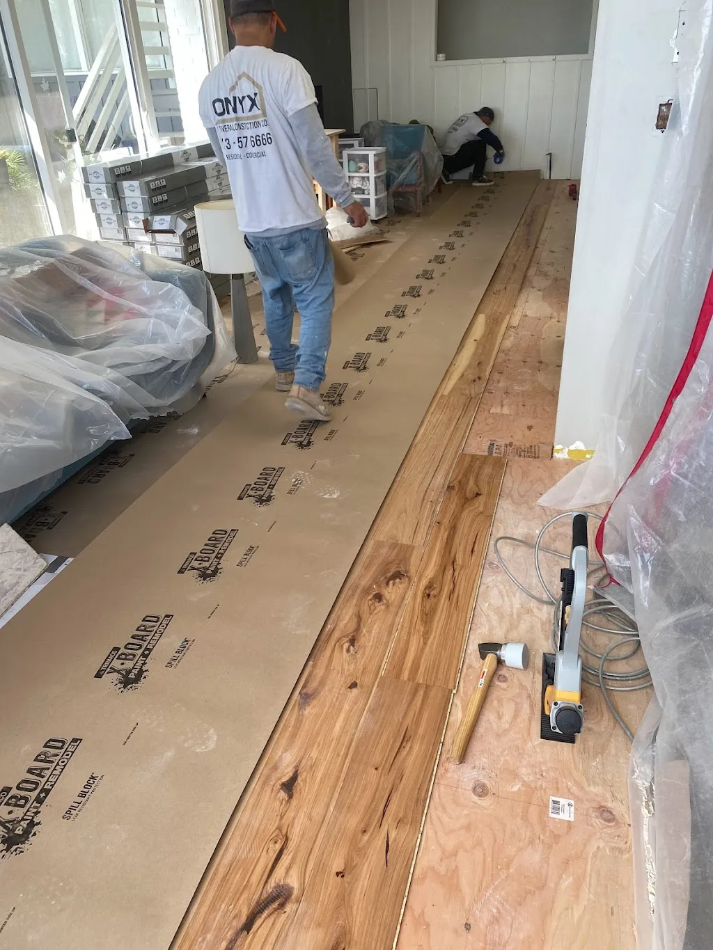 Flooring installation in view park General Contractor Construction Company Los Angeles - Kitchen, bathroom, laundry room remodel with seamless wood flooring installation in the living room and first floor of the house in Baldwin Hills View Park