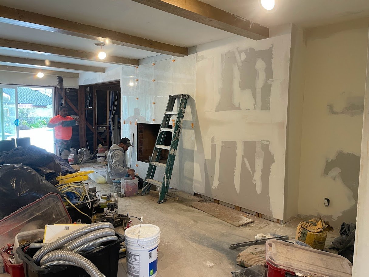 Fireplace wall drywall and tile preparation in Los Angeles.