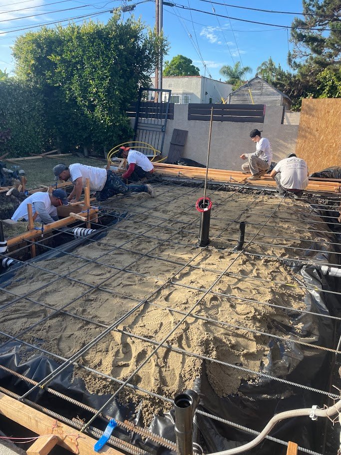 Rebar grid and under-slab plumbing layout for a Los Angeles ADU foundation.