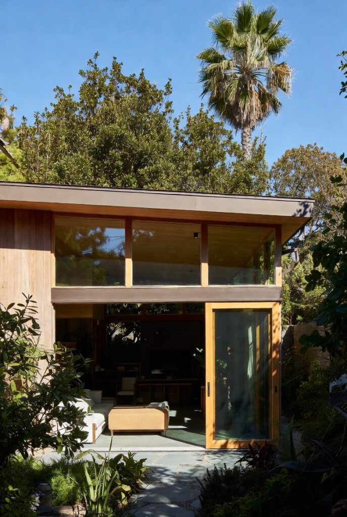 Mid-century modern inspired backyard home addition with sliding glass doors and natural wood finishes by Onyx General Construction.