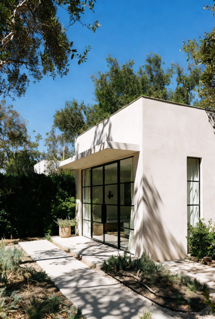 Modern one-story ADU in Los Angeles with smooth limestone-style stucco, black steel-frame windows, drought-tolerant landscaping, and clean architectural lines built by Onyx General Construction Company