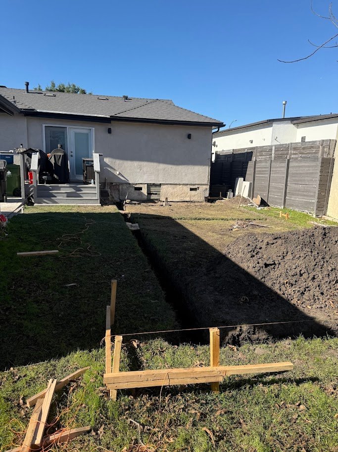 Backyard trenching and preparation for a Los Angeles addition foundation.