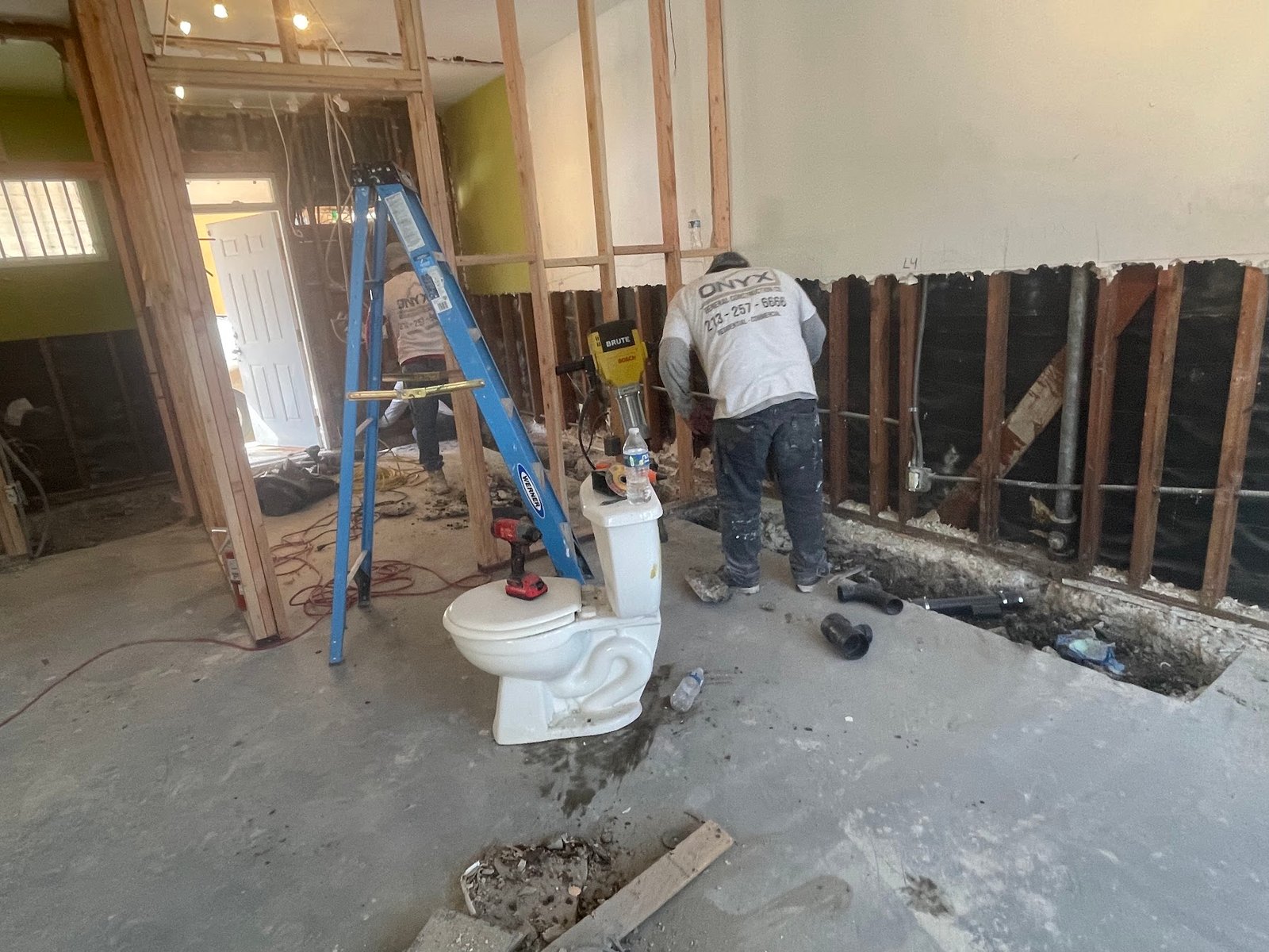 Interior slab cutting for plumbing and foundation preparation.