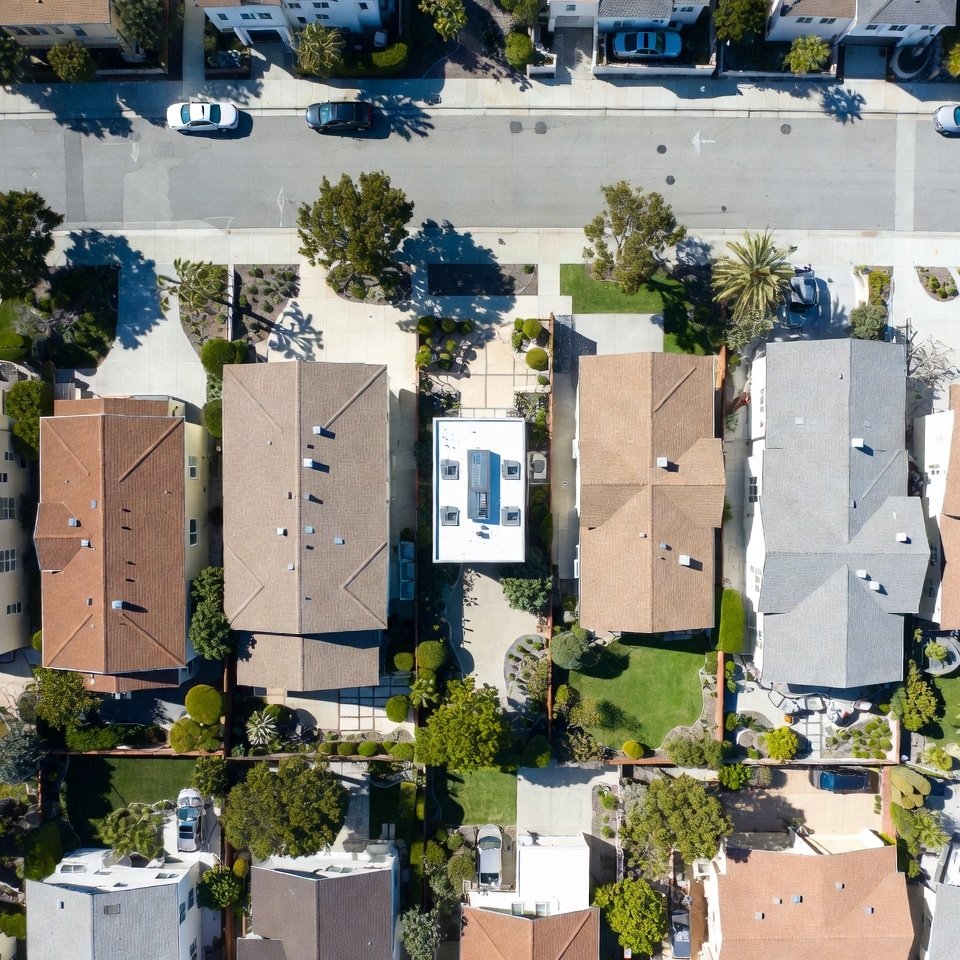 Aerial view of a detached backyard ADU behind a single-family home in a well-kept West Los Angeles neighborhood.
